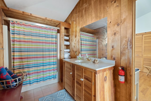 0 Burr Is, Branford, CT 06405 - full bath featuring a shower with curtain, vanity, wood walls, lofted ceiling, and tile patterned floors