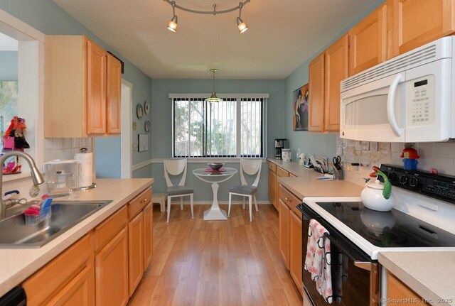 894 Heritage Vlg Unit B, Southbury, CT 06488 - kitchen with range with electric cooktop, a sink, light countertops, white microwave, and backsplash