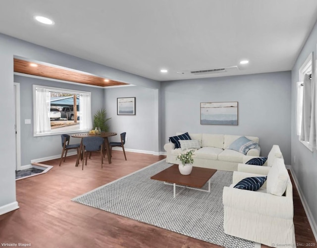 living room featuring baseboards, recessed lighting, and wood finished floors