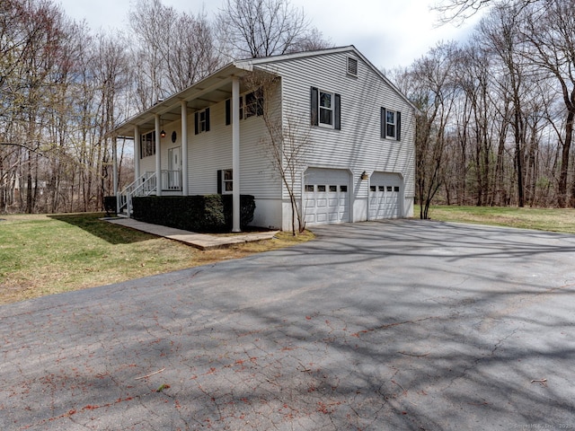 view of property exterior featuring a lawn, driveway, and an attached garage