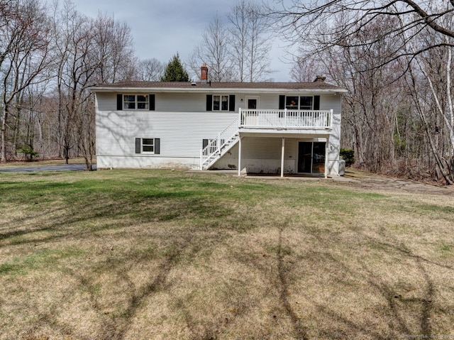 back of house with a chimney, stairway, and a lawn