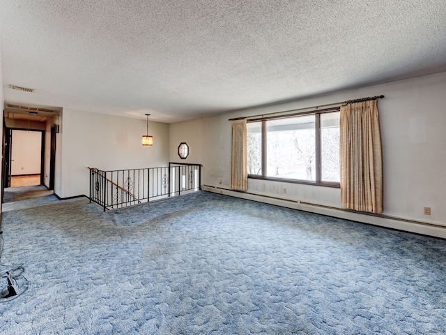 unfurnished room with a textured ceiling, visible vents, a baseboard heating unit, carpet flooring, and baseboards
