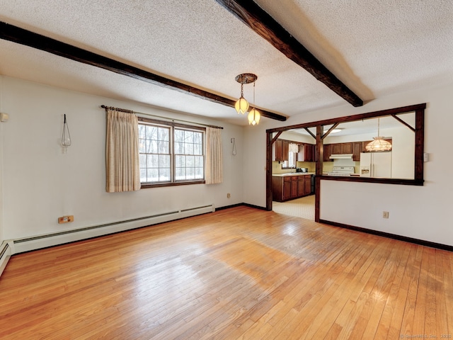 empty room featuring light wood-style floors, a textured ceiling, baseboard heating, baseboards, and beam ceiling