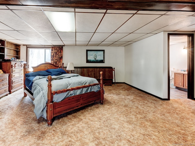 bedroom featuring baseboards, a drop ceiling, and carpet floors