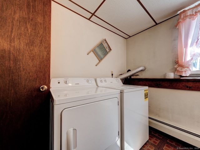 laundry room featuring washing machine and clothes dryer, brick patterned floor, laundry area, and baseboard heating