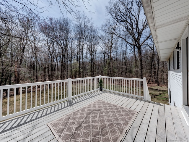 wooden terrace featuring a forest view