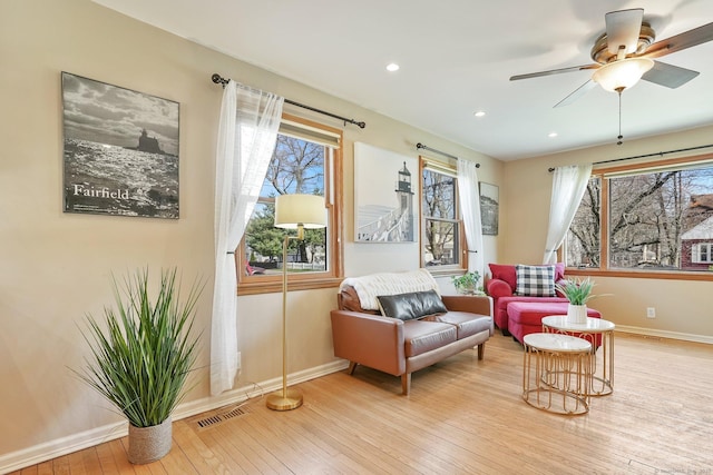 sitting room with recessed lighting, light wood-style flooring, visible vents, and baseboards