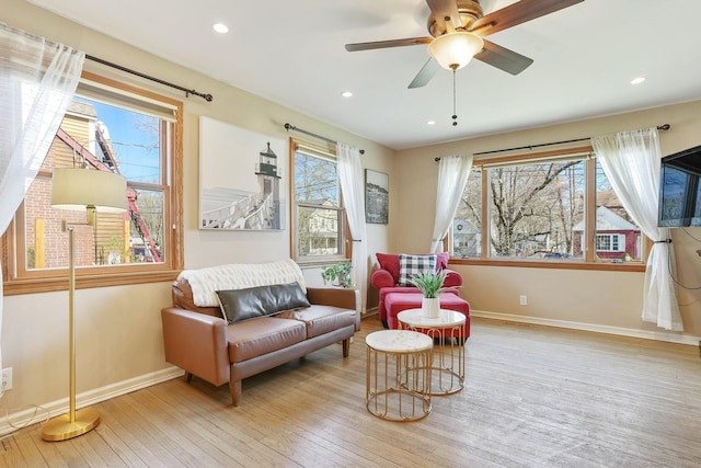 living area featuring hardwood / wood-style floors, baseboards, recessed lighting, and ceiling fan