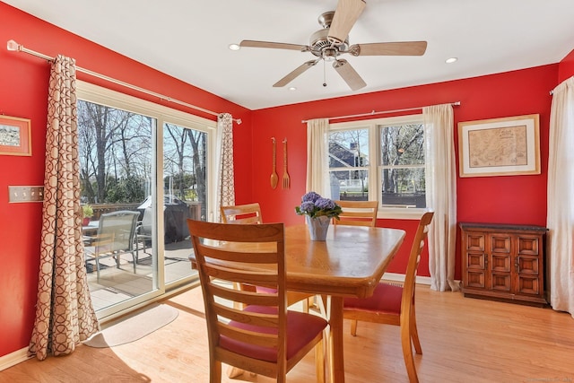 dining space with ceiling fan, baseboards, light wood-style flooring, and plenty of natural light