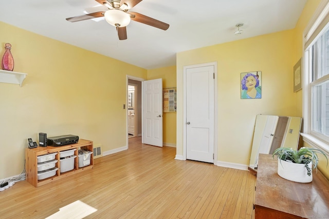 miscellaneous room with a ceiling fan, visible vents, light wood finished floors, and plenty of natural light