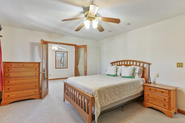bedroom with ceiling fan, baseboards, and light carpet