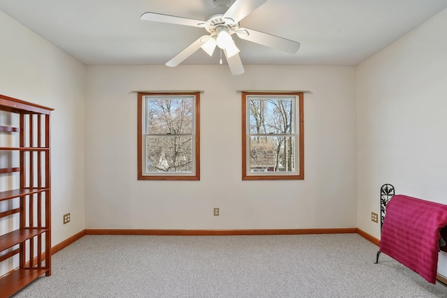 unfurnished room featuring baseboards, a ceiling fan, and carpet flooring