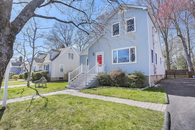 view of front of house with fence and a front yard