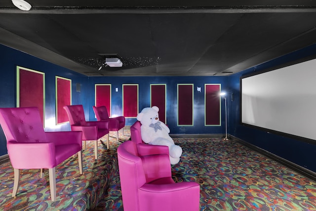 carpeted home theater featuring baseboards