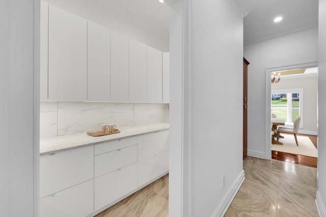 interior space with baseboards, recessed lighting, and an inviting chandelier