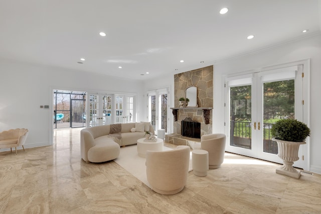 living area with french doors, marble finish floor, ornamental molding, and a stone fireplace