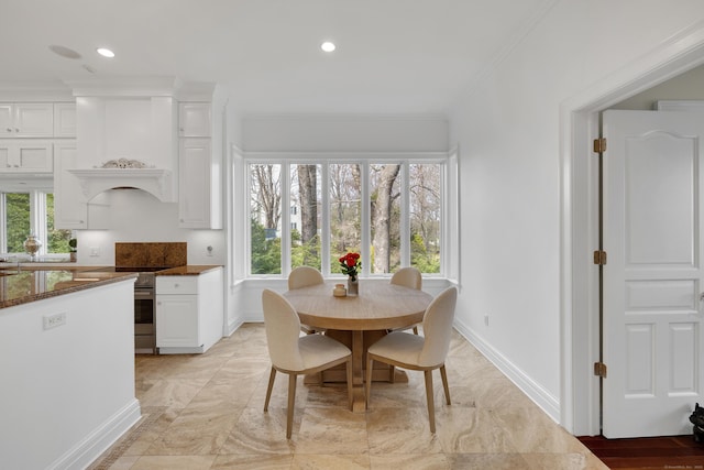 dining area featuring crown molding, baseboards, plenty of natural light, and recessed lighting