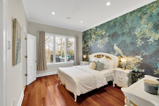 bedroom with baseboards, wallpapered walls, crown molding, and wood finished floors