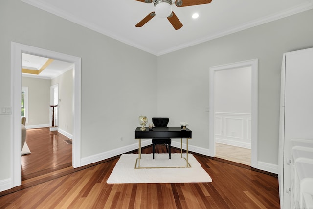 home office featuring baseboards, crown molding, a ceiling fan, and wood finished floors