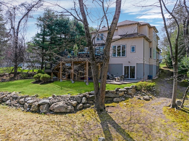 rear view of property with a patio area and a lawn