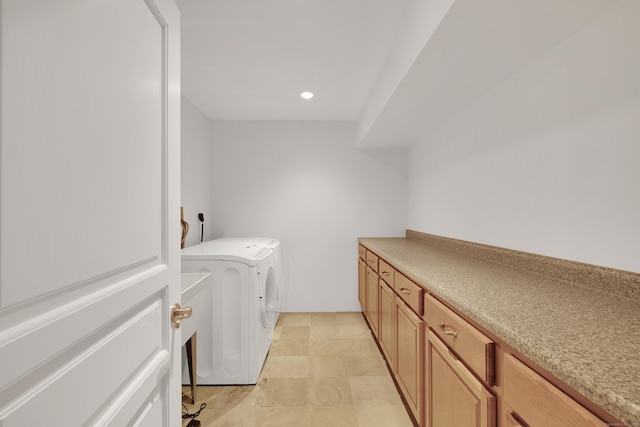 washroom featuring washer and dryer, cabinet space, and recessed lighting