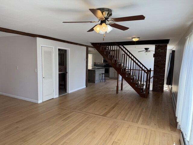 230 Old Field Rd, Southbury, CT 06488 - unfurnished living room featuring baseboard heating, stairs, light wood-type flooring, ceiling fan, and baseboards