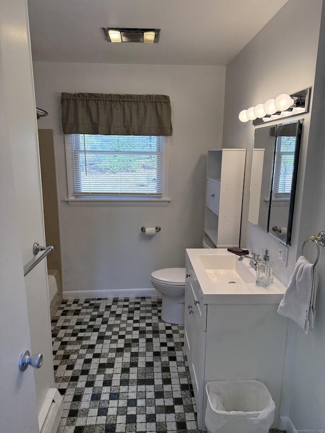 full bathroom with baseboards, visible vents, toilet, and vanity