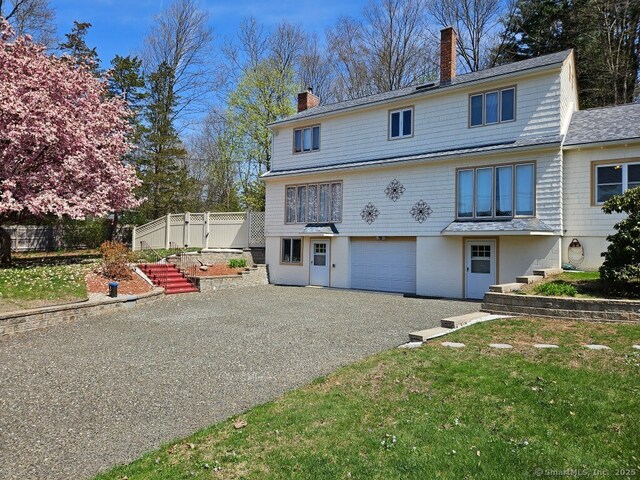 230 Old Field Rd, Southbury, CT 06488 - view of front of house with a chimney, an attached garage, driveway, and fence