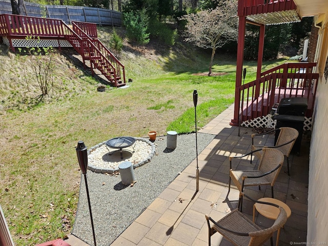view of patio / terrace featuring a fire pit and stairway