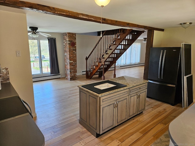 kitchen with freestanding refrigerator, light wood-style flooring, a ceiling fan, and baseboard heating