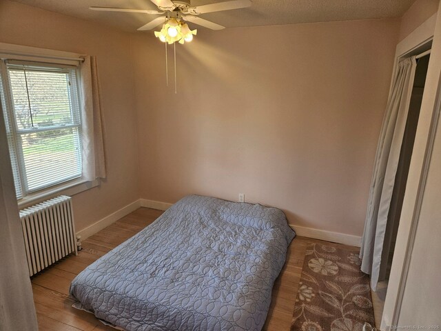 230 Old Field Rd, Southbury, CT 06488 - bedroom with radiator, baseboards, wood finished floors, and ceiling fan