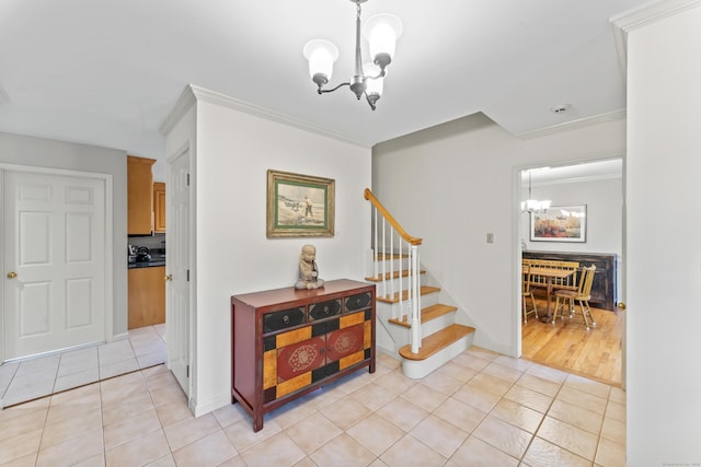 stairway with crown molding, tile patterned floors, a notable chandelier, and baseboards