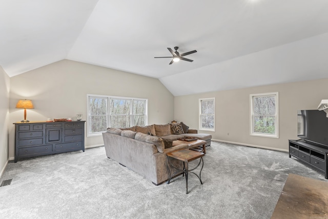 living room with ceiling fan, plenty of natural light, carpet, and lofted ceiling