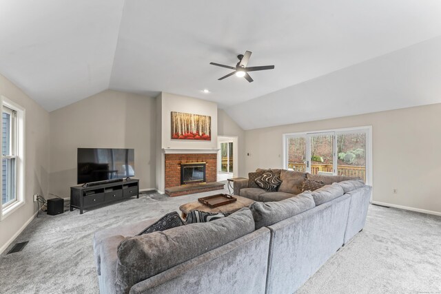 living room with lofted ceiling, visible vents, ceiling fan, and carpet floors