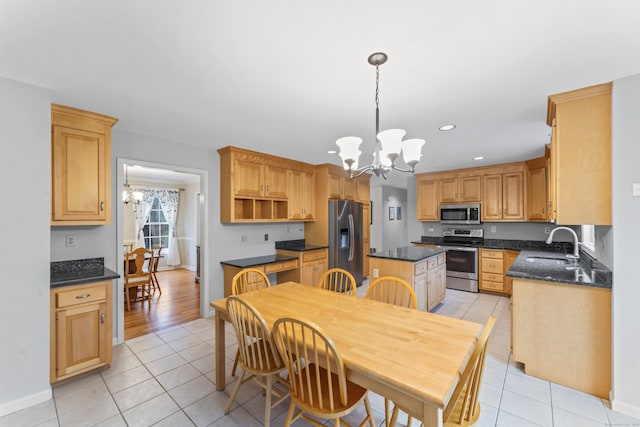 kitchen with a chandelier, light tile patterned floors, and stainless steel appliances