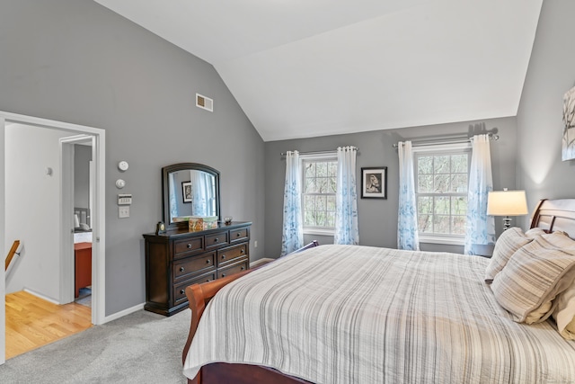 bedroom with visible vents, baseboards, carpet, and vaulted ceiling