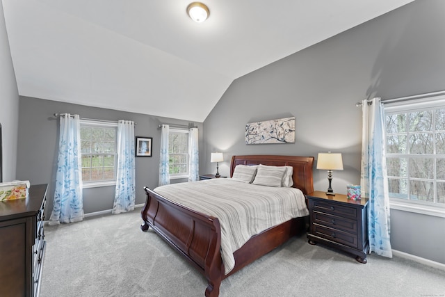 bedroom with baseboards, carpet flooring, and lofted ceiling