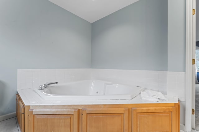 bathroom with a bath and tile patterned floors