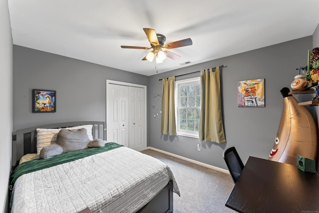 bedroom with a closet, baseboards, visible vents, a ceiling fan, and carpet floors