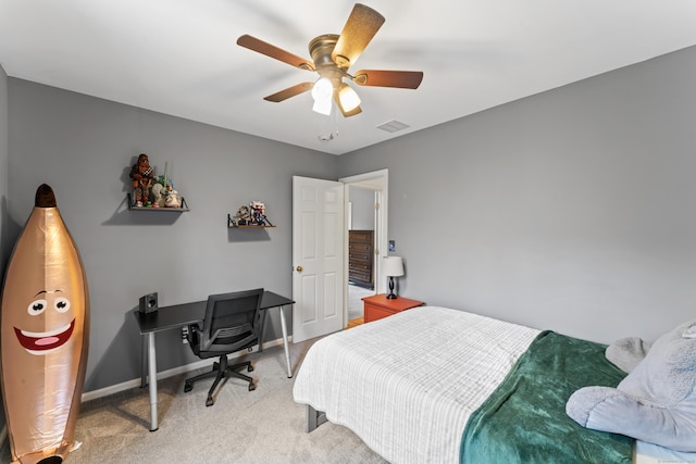 bedroom with visible vents, baseboards, ceiling fan, and light carpet