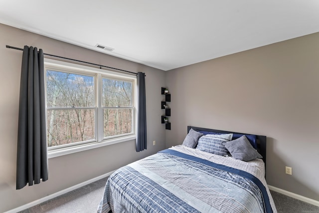carpeted bedroom featuring baseboards and visible vents