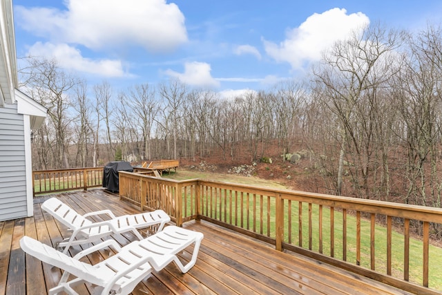 deck featuring grilling area and a lawn