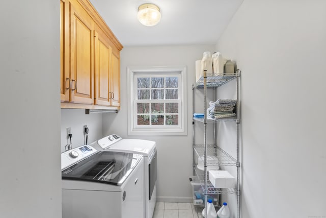 washroom featuring cabinet space, light tile patterned floors, independent washer and dryer, and baseboards