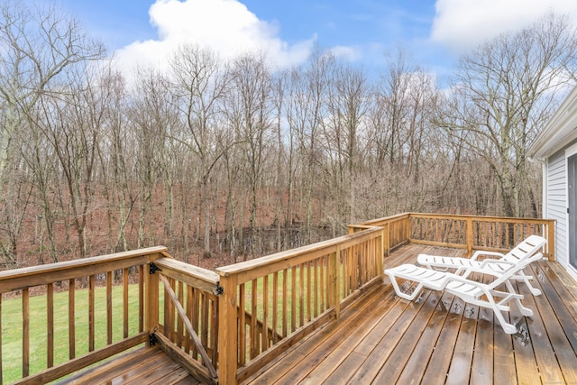wooden deck with a lawn