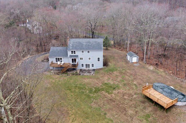 birds eye view of property with a forest view