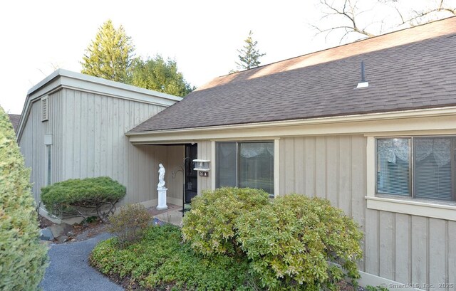 16 Heritage Vlg Unit A, Southbury, CT 06488 - doorway to property with a shingled roof