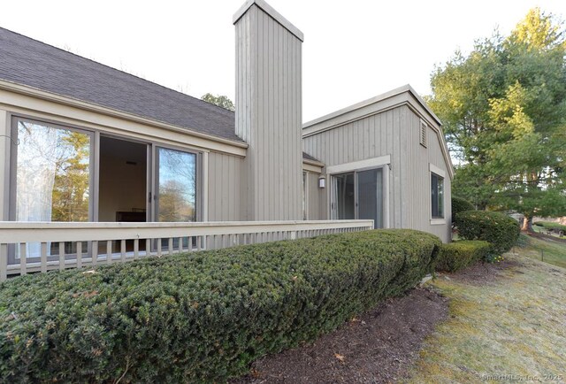 16 Heritage Vlg Unit A, Southbury, CT 06488 - view of side of property with a chimney