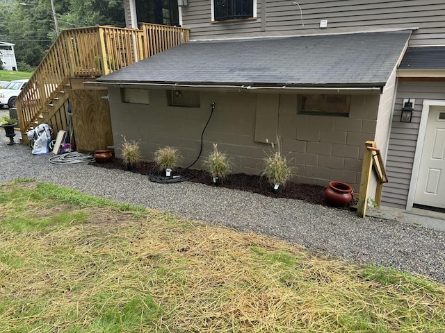 23 Main St, East Haddam, CT 06423 - view of side of property featuring stairs, concrete block siding, and roof with shingles