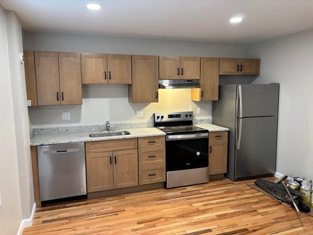 23 Main St, East Haddam, CT 06423 - kitchen with appliances with stainless steel finishes, under cabinet range hood, light wood-style floors, recessed lighting, and light stone counters