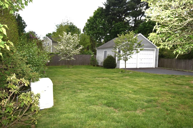 view of yard with an outbuilding and a detached garage